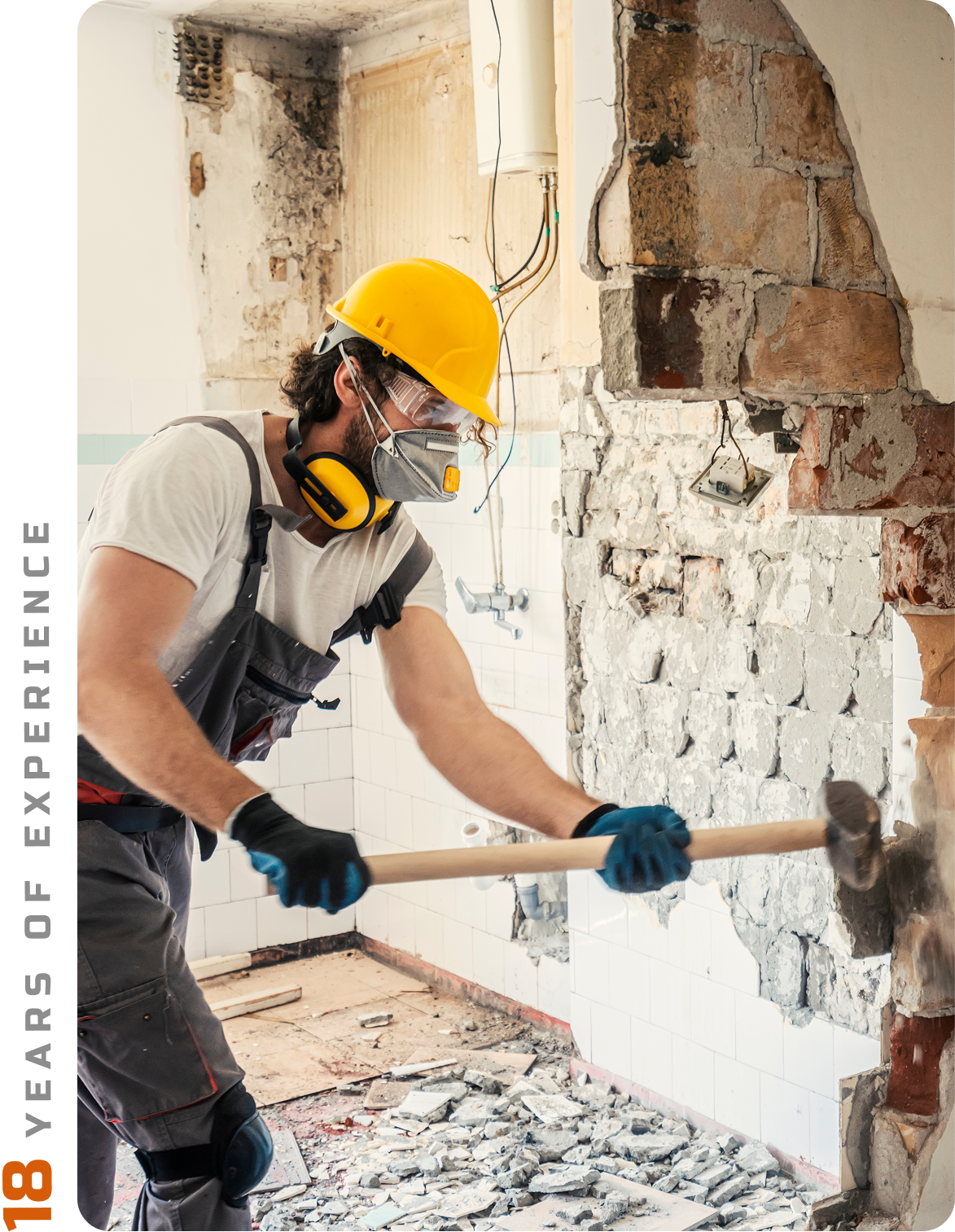 Worker using drill on construction site.