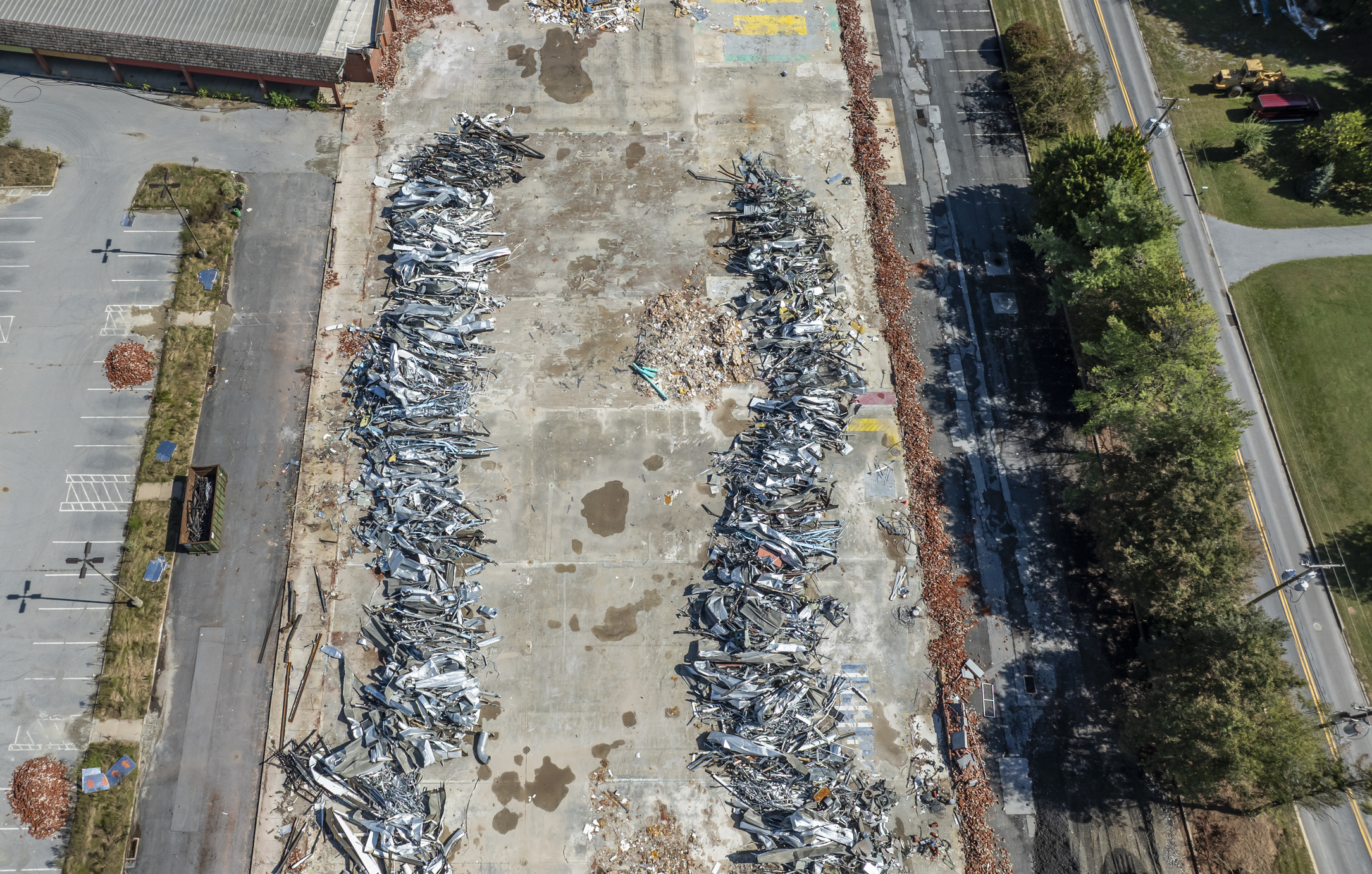 Aerial view of scrapyard with stacked metal.