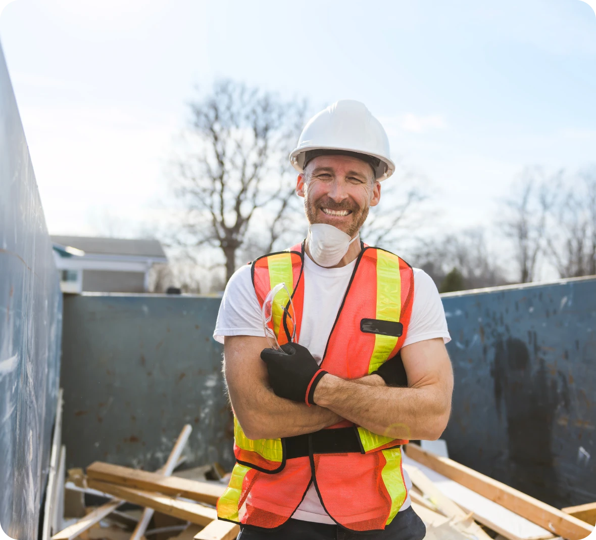 Smiling construction worker in safety gear outdoors.