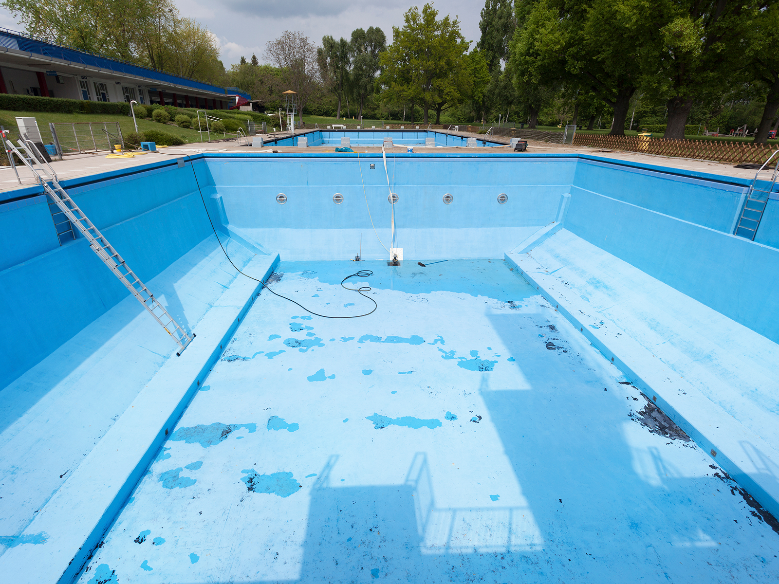 Empty outdoor swimming pool under maintenance.